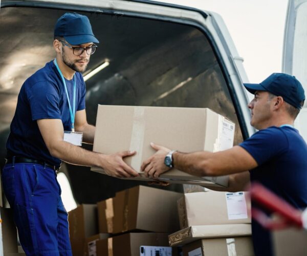 https://gilmor.eu/wp-content/uploads/2024/01/delivery-men-loading-carboard-boxes-van-while-getting-ready-shipment_637285-2289-600x500.jpg